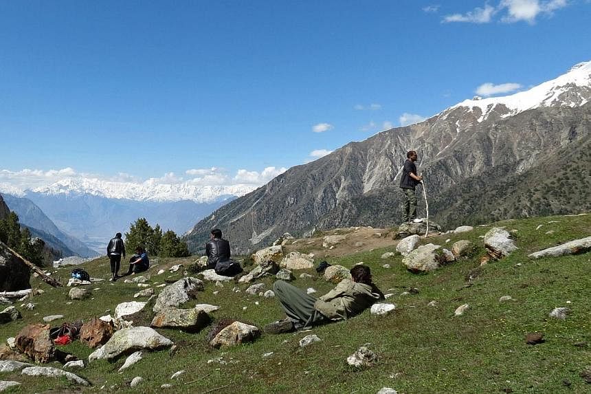 In this photograph taken on June 13, 2014, tourist enjoy the view near Nanga Parbat, Pakistan's second-highest mountain. A Chinese-American man was the main target in the June 22, 2013 massacre of 10 foreign climbers. -- PHOTO: AFP &nbsp;