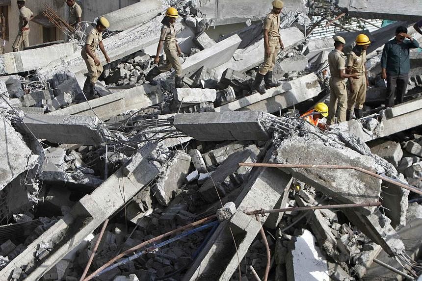 Rescue workers conduct a search operation for survivors at the site of a collapsed 11-storey building that was under construction on the outskirts of the southern Indian city of Chennai on June 29, 2014.&nbsp;Rescuers searched desperately for survivo