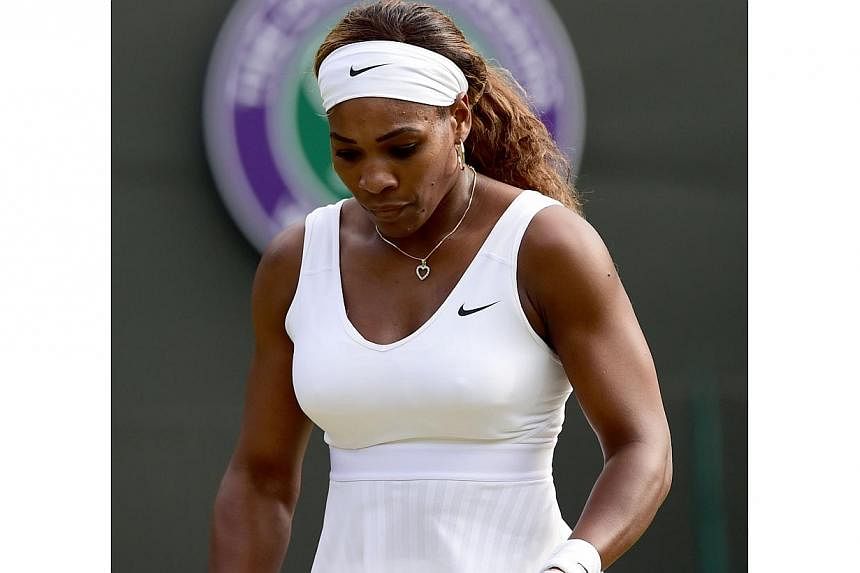 US player Serena Williams reacts during her women's singles third round match against France's Alize Cornet on day six of the 2014 Wimbledon Championships at The All England Tennis Club in Wimbledon, southwest London, on June 28, 2014. -- PHOTO: AFP