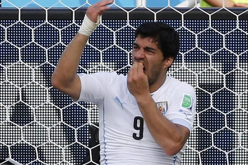 Uruguay forward Luis Suarez holding his teeth after the biting incident during the Group D World Cup match between Italy and Uruguay last Tuesday.