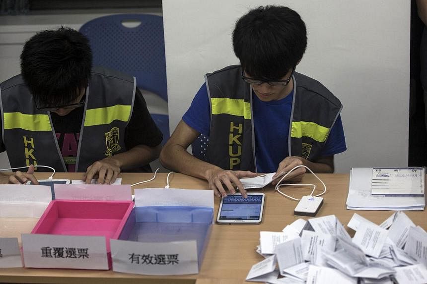 Electoral assistants count ballots at a polling station after the last day of civil referendum held by the Occupy Central organisers in Hong Kong on June 29, 2014. More than 780,000 votes were cast by the final day of an unofficial referendum on demo