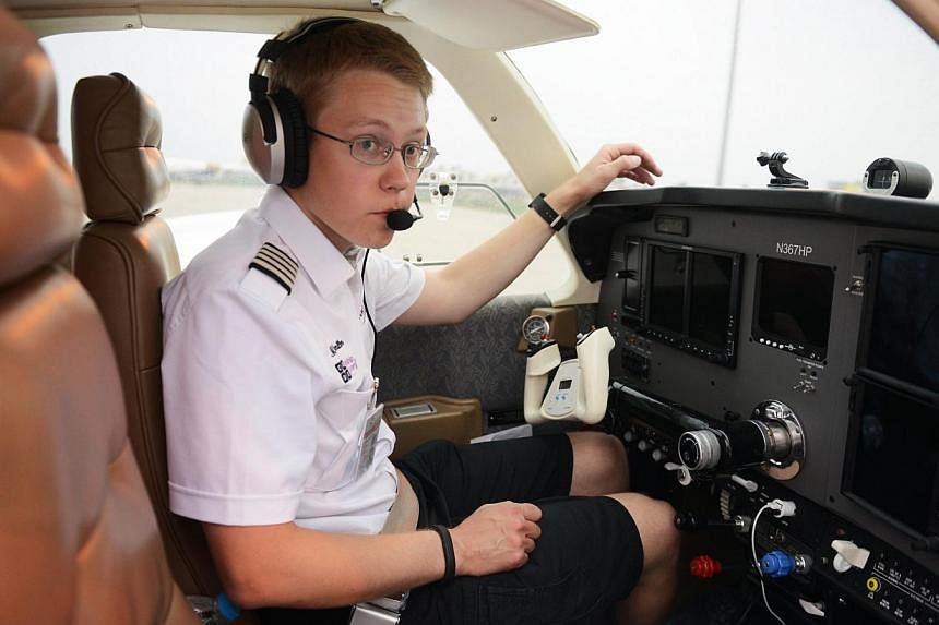 US pilot Matt Guthmiller sits in the cockpit of his single-engined Beechcraft A36 Bonanza aircraft before his departure from the Dr Babasaheb Ambedkar International Airport in Nagpur on June 27, 2014. -- PHOTO: AFP