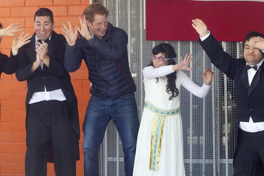 Britain's Prince Harry (third from left) participates in a performance during his visit to a school for children with disabilities during the last day of his tour in Santiago June 29, 2014. -- PHOTO: REUTERS&nbsp;