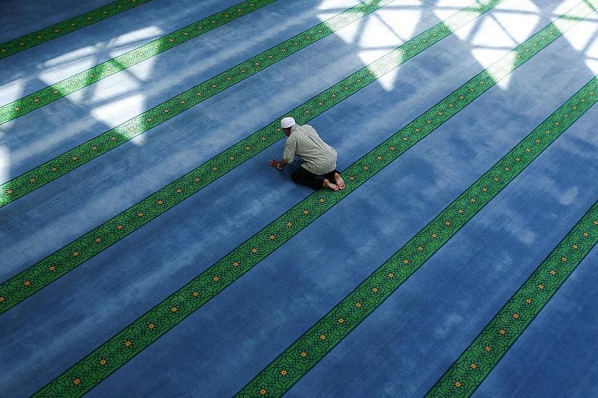 A Malaysian Muslim prays during a lunch break on the 2nd day of the holy month of Ramadan inside a mosque in Kuala Lumpur June 30, 2014. Muslims are observing the fasting month of Ramadan, Islam's holiest month, during which observant believers fast 