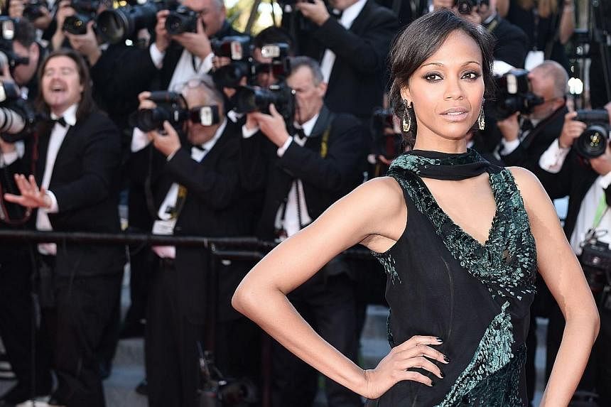 US actress Zoe Saldana poses as she arrives for the screening of the film Mr Turner at the 67th edition of the Cannes Film Festival in Cannes, southern France, on May 15, 2014. The Avatar star will be here from July 10 to 12 to promote her new movie,