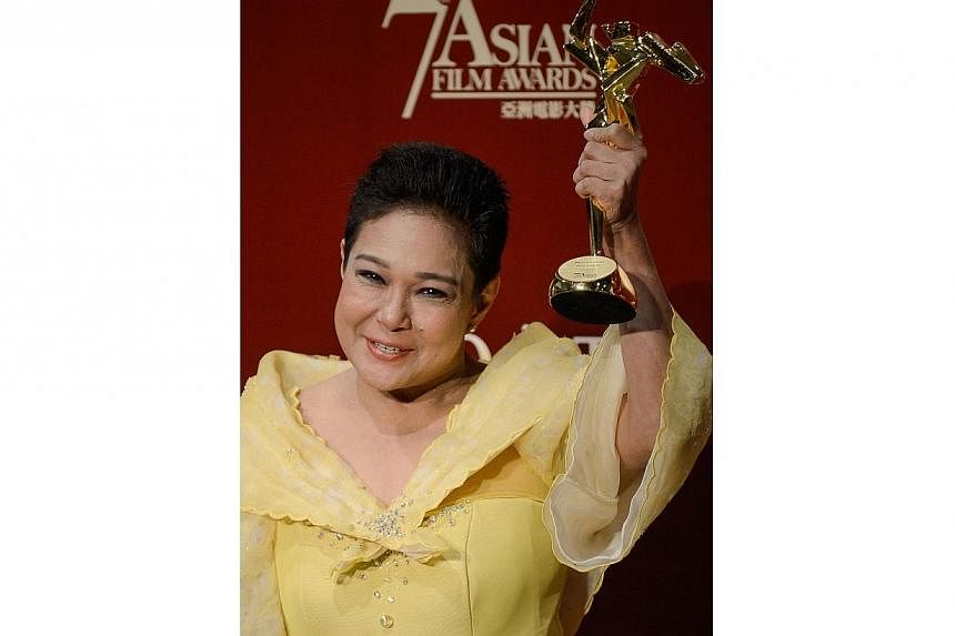 This file photo taken on March 18, 2013 shows Philippine actress Nora Aunor posing with the Best Actress Award at the 7th Asian Film Awards in Hong Kong.&nbsp;Philippines President Benigno Aquino on Tuesday defended a controversial decision he made t