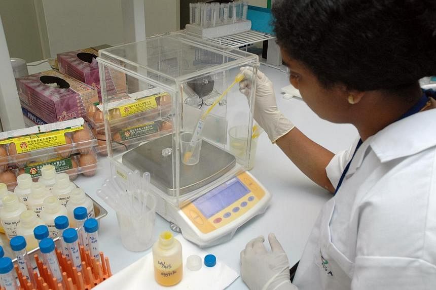 A scientist conducts tests at the Agri-Food and Veterinary Authority's Veterinary Public Health Centre. The World Organisation for Animal Health has endorsed the AVA's facility as South-east Asia's first collaborating centre. -- PHOTO: AVA
