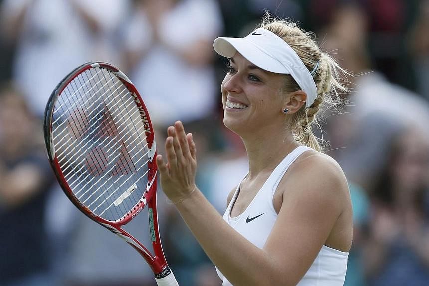 Sabine Lisicki of Germany reacts after defeating Yaroslava Shvedova of Kazakhstan in their women's singles tennis match at the Wimbledon Tennis Championships, in London on July 1, 2014. -- PHOTO: REUTERS
