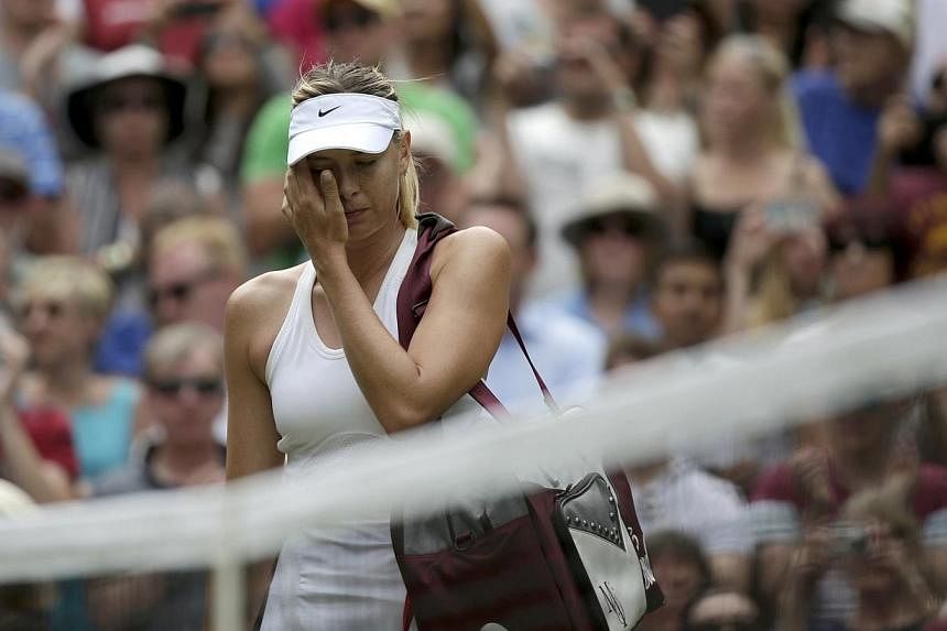Maria Sharapova of Russia reacts after being defeated by Angelique Kerber of Germany in their women's singles tennis match at the Wimbledon Tennis Championships, in London on July 1, 2014.&nbsp;Maria Sharapova suffered more Wimbledon heartache as the