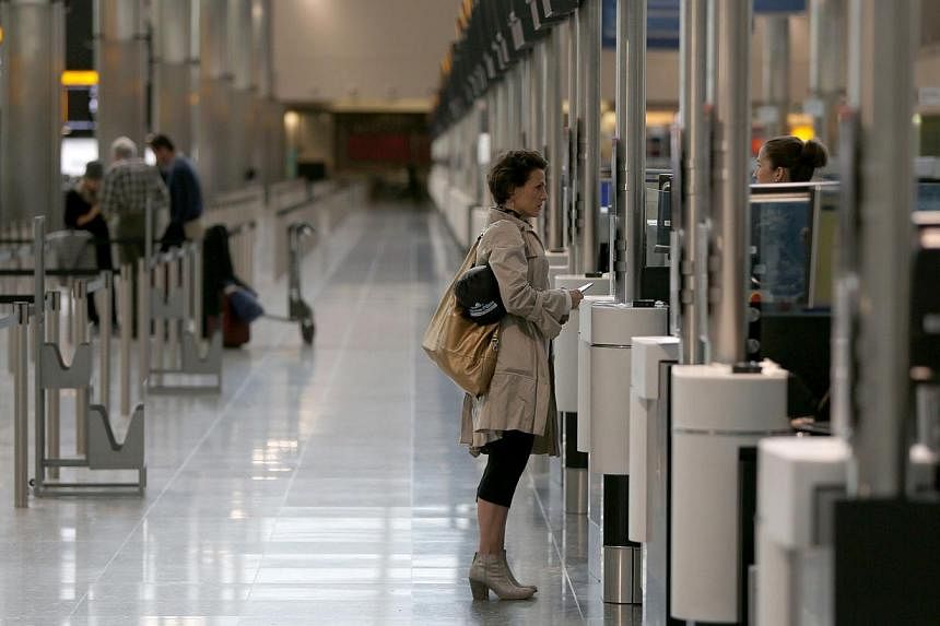 A woman checks-in in Terminal 2 at Heathrow Airport in London June 4, 2014. -- PHOTO: REUTERS