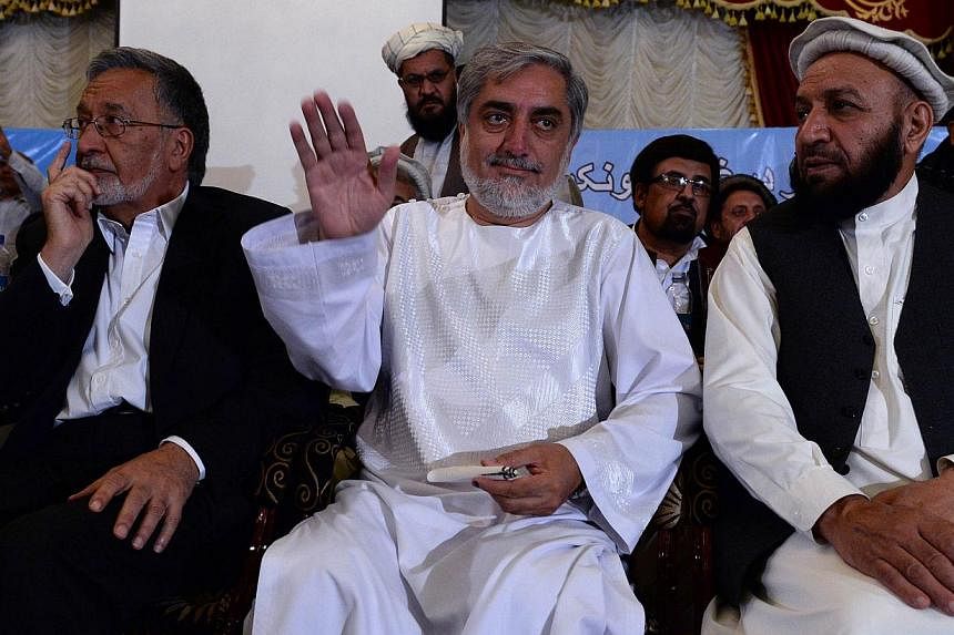 Afghan presidential candidate Abdullah Abdullah (C) gestures during a gathering with tribal elders in Kabul June 28, 2014. Abdullah has vowed to reject the country's general election result, saying he was the victim of massive ballot-box stuffing in 