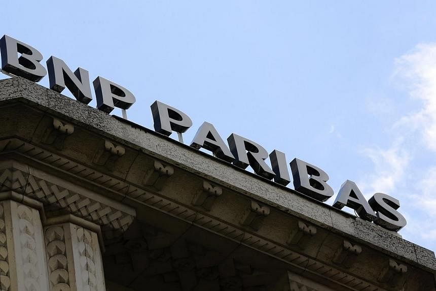 The logo of French bank BNP Paribas is seen above the facade of their central Paris agency on June 30, 2014.&nbsp;France’s banking regulator said on Monday BNP Paribas could “absorb the anticipated consequences” of an US$8.9 billion (S$11.1 bil