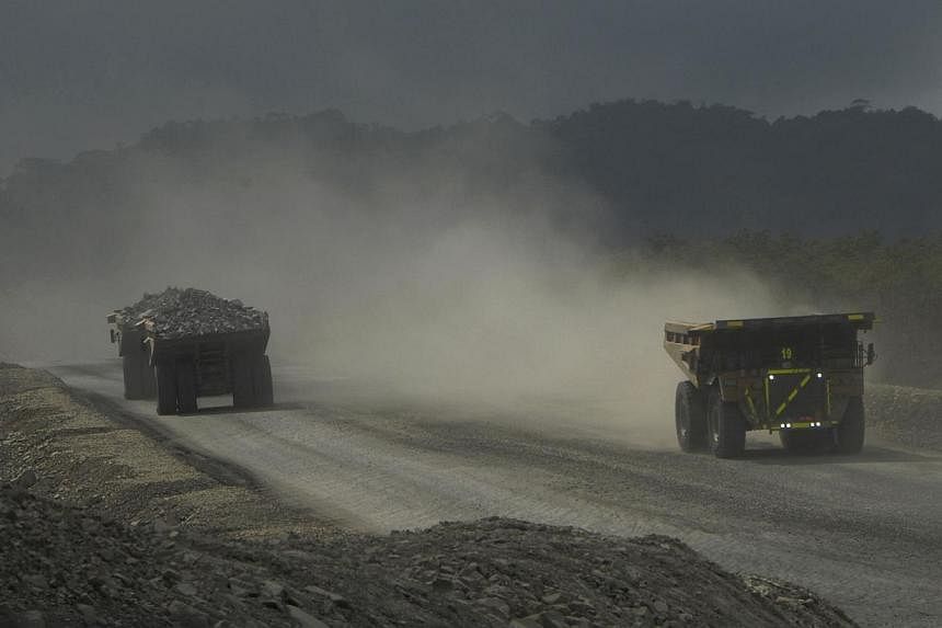 File picture of trucks carrying ore at Newmont Mining Corp's copper and gold mine are seen driving on Indonesia's Sumbawa island. Newmont Mining Corp, one of two big foreign copper miners in Indonesia, said on Tuesday it has halted production of copp