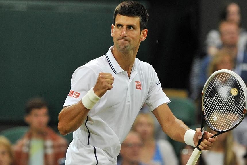 Serbia's Novak Djokovic celebrates winning a game against France's Jo-Wilfried Tsonga during their men's singles fourth round match on day seven of the 2014 Wimbledon Championships at The All England Tennis Club in Wimbledon, southwest London, on Jun
