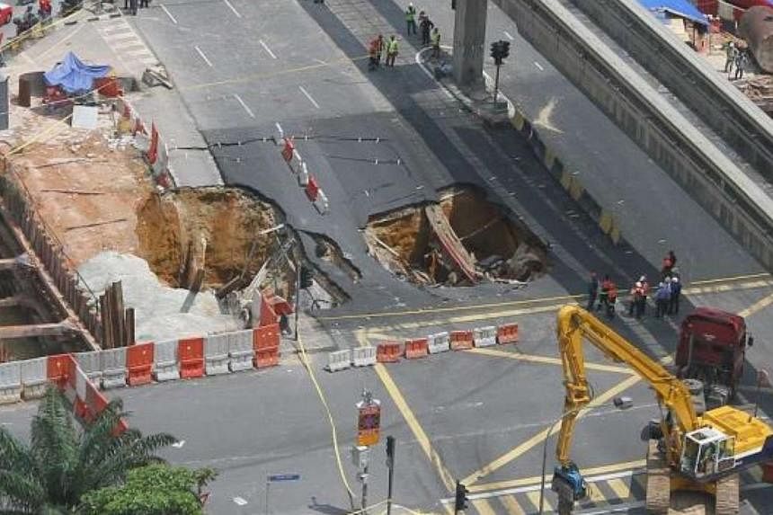 Excavation works for an underground tunnel caused a road collapse at the intersection of Jalan Pudu and Jalan Hang Tuah in the Kuala Lumpur city centre. -- PHOTO: THE STAR/ASIA NEWS NETWORK