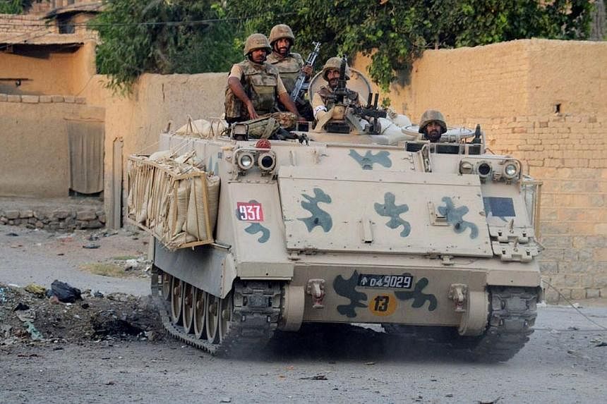 This handout picture released by the Inter Services Public Relations (ISPR) on July 1, 2014, shows Pakistani soldiers riding an armoured vehicle during a military operation against Taleban militants in the main town of Miranshah in North Waziristan. 