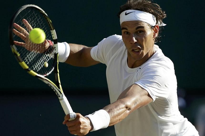 Rafael Nadal of Spain hits a return during his men's singles tennis match against Nick Kyrgios of Australia at the Wimbledon Tennis Championships, in London on July 1, 2014. -- PHOTO: REUTERS