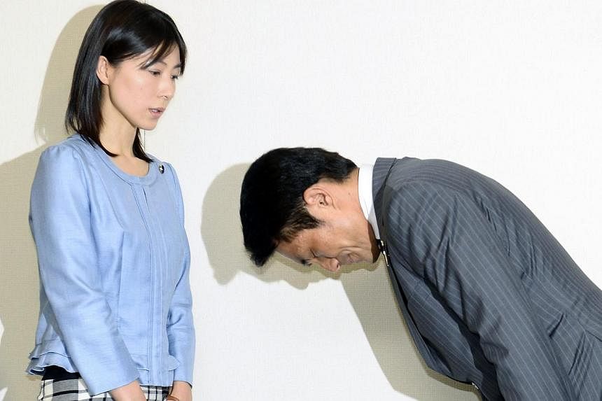 Tokyo city assembly lawmaker Akihiro Suzuki (right) apologising to lawmaker Ayaka Shiomura, in Tokyo, last week, for yelling comments such as "You should get married!" while she was speaking to the assembly.