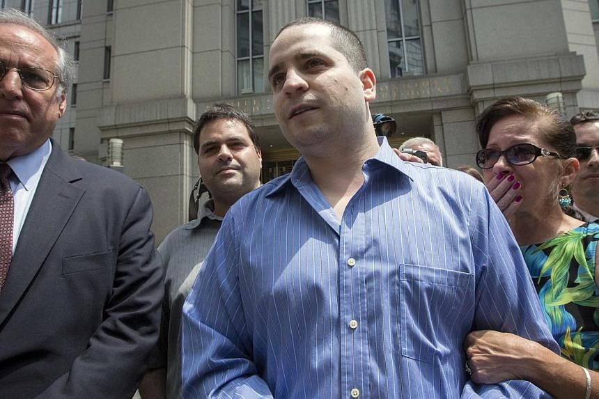 Former New York City police officer Gilberto Valle (centre), dubbed by local media as the "Cannibal Cop," leaves the US District Court for the Southern District of New York in Lower Manhattan, July 1, 2014. -- PHOTO: REUTERS