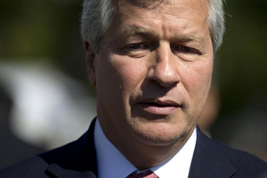 JPMorgan Chase &amp; Co Chief Executive Officer Jamie Dimon arrives at the White House in Washington in this October 2, 2013 file photo. Dimon told the bank's employees and shareholders on July 1, 2014 that he has been diagnosed with curable throat c