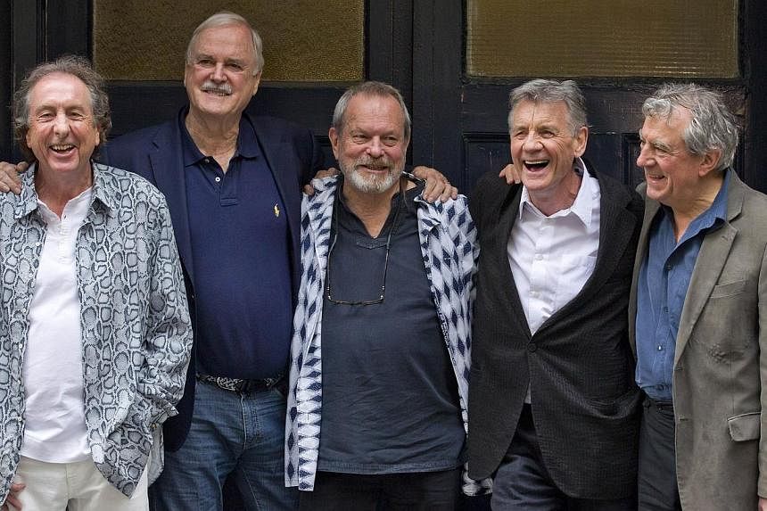 British comedy troupe Monty Python, (left-right) Eric Idle, John Cleese, Terry Gilliam, Michael Palin, and Terry Jones pose for a photograph at the back door to the London Palladium in central London on June 30, 2014.&nbsp;Fans arrived for the first 