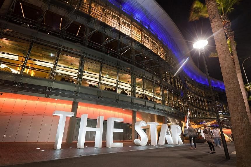 Pedestrians walk past The Star casino, operated by Echo Entertainment Group Ltd., in Sydney, Australia, on Friday, March 16, 2012. -- PHOTO: BLOOMBERG