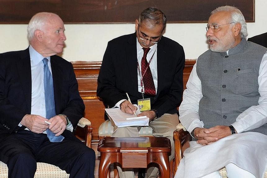 In this handout photograph received from the Press Information Bureau (PIB) on July 3, 2014 US Senator, John McCain (left) calls on Indian Prime Minister, Narendra Modi in New Delhi. Mr Modi pushed for improving US ties during a meeting with Mr McCai