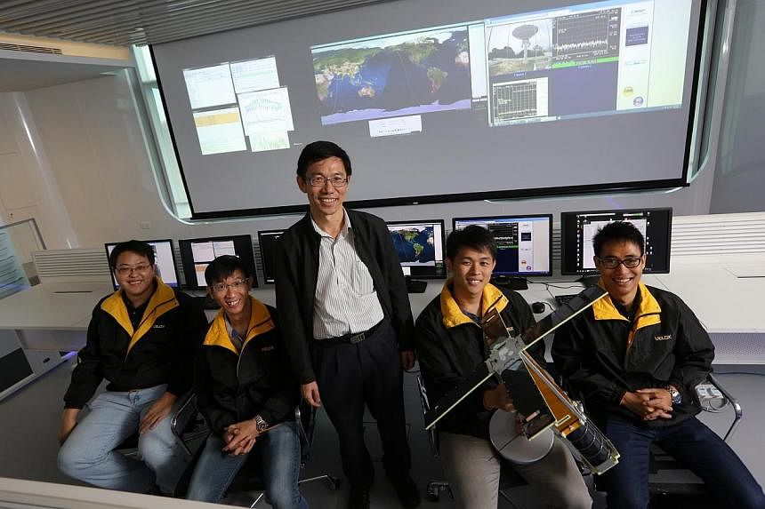 Director of NTU Satellite Research Centre Assoc Prof Low Kay Soon (centre, standing) with some of his students who built the VELOX-I.&nbsp;Locally-built satellites VELOX-I and VELOX-PIII were launched into space by a rocket from India at 12.21pm Sing
