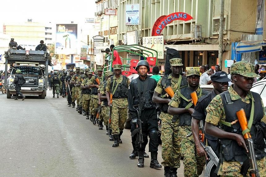 UPDF soldiers and police forces patrol streets in Kampala with a tactical operation vehicle on July 3 2014 after the US embassy in Uganda warned on Thursday of a "specific threat" by an unknown group to attack Entebbe international airport, which ser