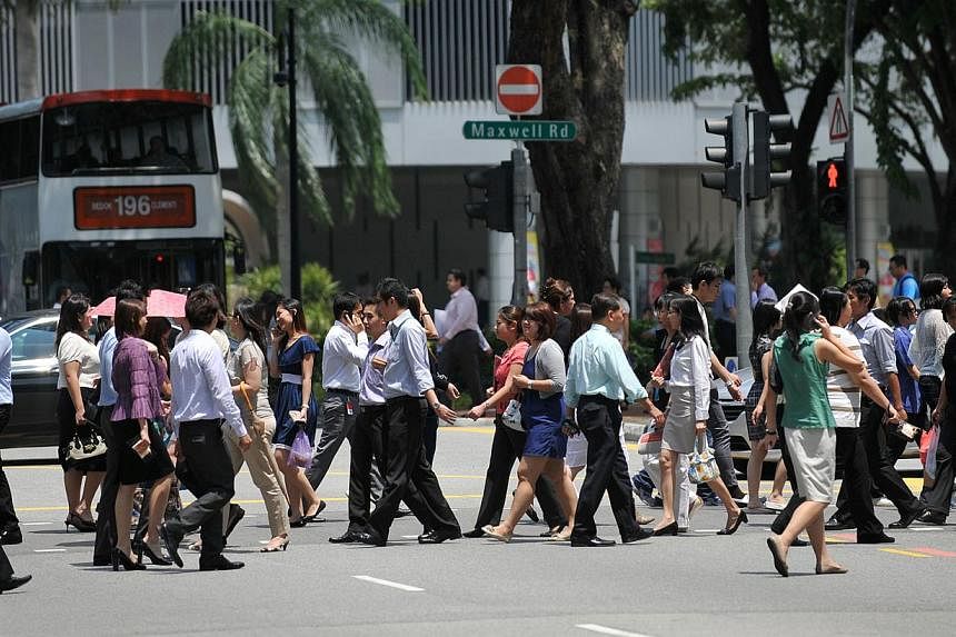 Office workers crossing Maxwell Road in the central business district (CBD) area on 10 August 2011. -- PHOTO: ST FILE
