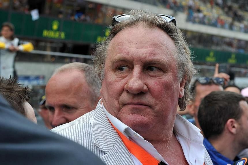 French actor Gerard Depardieu stands in the pit lane before the start of the 82nd 24 Hours of Le Mans endurance race in Le Mans, western France on June 14, 2014. Depardieu - who raised eyebrows when he took Russian nationality 18 months ago after bef