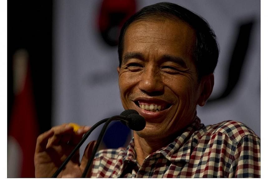 Indonesian frontrunner presidential candidate Joko Widodo, popularly known by his nickname Jokowi, addresses supporters during campaign for the July 9, 2014 election in his hometown in Solo city, located in central Java island on June 14, 2014. Mr Wi