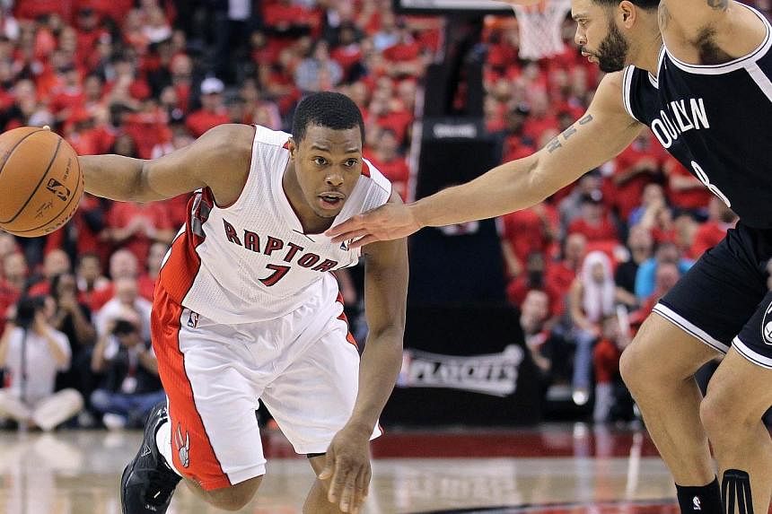 Kyle Lowry #7 of the Toronto Raptors tries to drive around Deron Williams #8 of the Brooklyn Nets in Game Seven of the NBA Eastern Conference Quarterfinals at the Air Canada Centre on May 4, 2014, in Toronto, Ontario, Canada. Lowry, who helped Toront