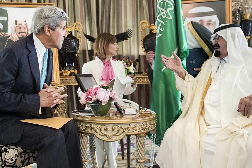 Saudi King Abdullah bin Abdulaziz al-Saud (right) and U.S. Secretary of State John Kerry wait for a meeting at the King's private residence in the Red Sea city of Jeddah on June 27, 2014.&nbsp;Top US officials on Wednesday upped pressure on key Iraqi