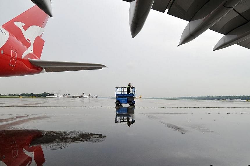 A Qantas A380 plane on the tarmac at Changi Airport.&nbsp;A Qantas A380 superjumbo flight from Los Angeles to Melbourne turned back an hour after take-off when a water leak flooded the plane's aisles, the airline and passengers said Thursday. -- PHOT