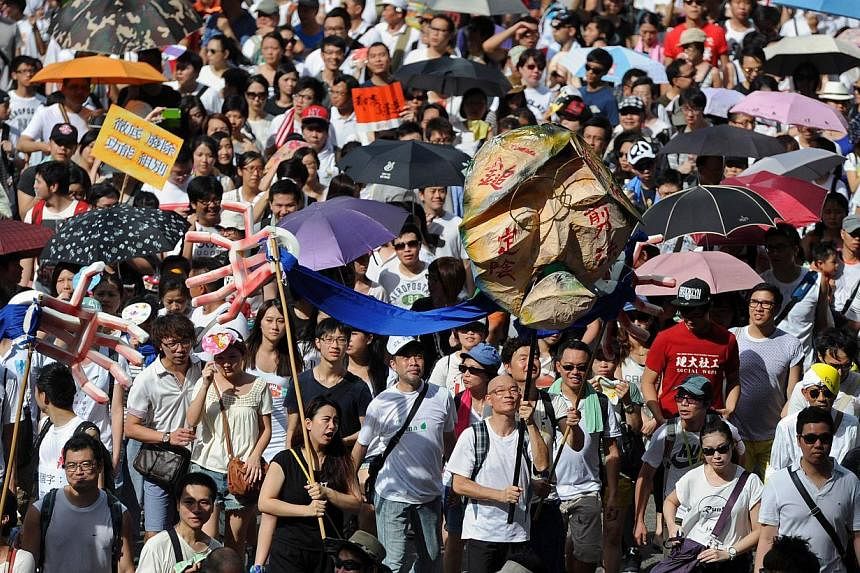 Protesters marching during a pro-democracy rally seeking greater democracy in Hong Kong. China's top newspaper on Friday dismissed fears that the autonomy of the former British colony of Hong Kong was being eroded, saying Beijing's policy had not and