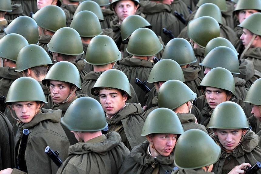 Belarus troops dressed as Soviet Red Army soldiers of the World War II-era stand in central Minsk, on July 3 , 2014, during the Independence Day military parade. -- PHOTO: AFP &nbsp;
