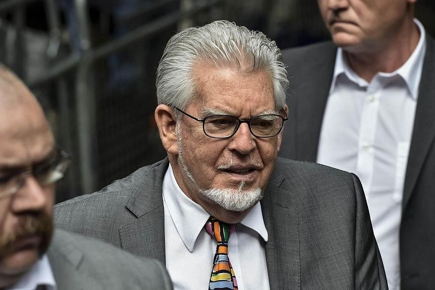 Veteran entertainer Rolf Harris (centre) arrives at Southwark Crown Court in central London on July 4, 2014.&nbsp;Harris, a household name in Britain and Australia for decades, was on Friday, July 4, 2014, jailed for five years and nine months by a j