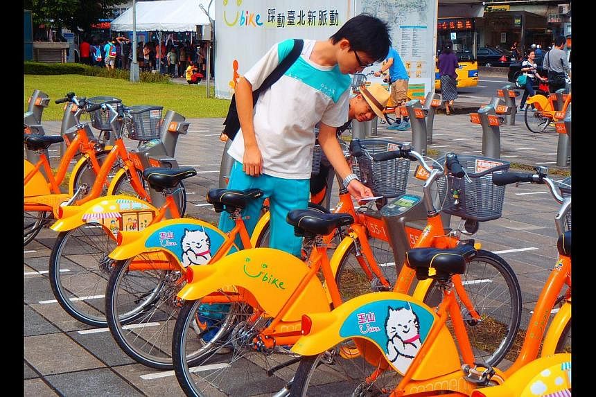 A commuter choosing a bike at a YouBike station atop Taipei City Hall MRT station. The Taiwanese city piloted its bike-share system in 1998, in part to tackle traffic congestion.