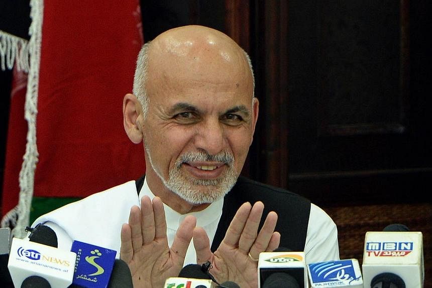 Afghan presidential candidate Ashraf Ghani gestures as he addresses a press conference in Kabul on July 5, 2014.&nbsp;Mr Ashraf Ghani ruled out a coalition government with his rival Abdullah Abdullah on Saturday, July 5, 2014, quashing hopes for a po