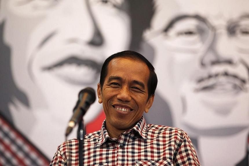 Presidential candidate Joko Widodo smiles during a news conference in Bandung on July 3, 2014.&nbsp;Presidential candidate Widodo plans to go to Saudi Arabia for a minor haj or umrah during the quiet period to seek God's blessing ahead of the electio