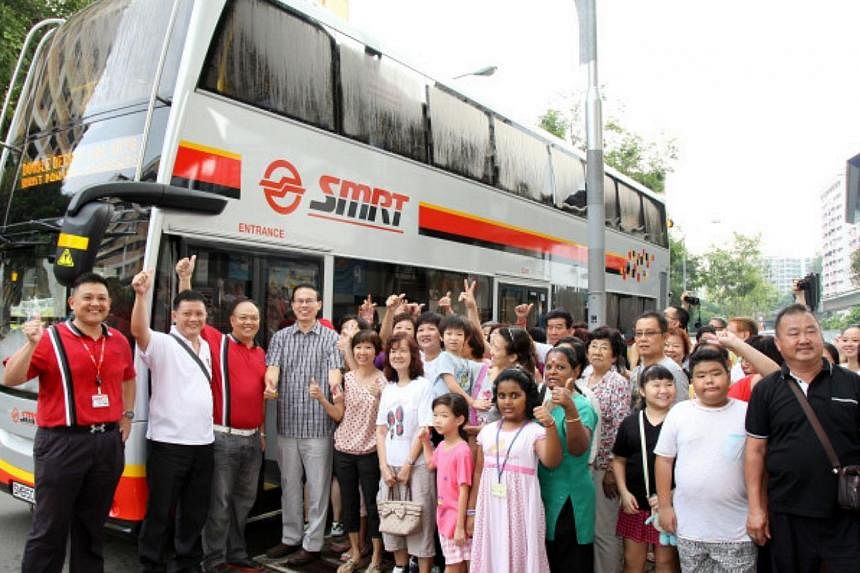 Bukit Panjang Adviser Teo Ho Pin (fourth from left) and other Bukit Panjang grassroots leaders at a preview event of SMRT's new double decker buses on Sunday, July 6, 2014. Three of the new buses will be added to service 972 from July 13, with more b