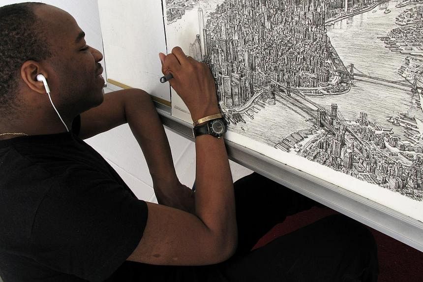 British architectural artist Stephen Wiltshire - who is a savant with exceptional talent in art, music and memory - drawing an aerial view of Manhattan. Known for intricate drawings of cityscapes, he will be in Singapore later this month to draw the 