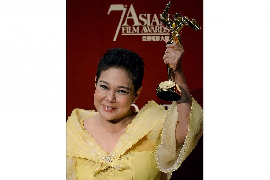 This file photo taken on March 18, 2013 shows Philippine actress Nora Aunor posing with the Best Actress Award at the 7th Asian Film Awards in Hong Kong. Philippines President Benigno Aquino on July 1, 2014 defended a controversial decision he made t