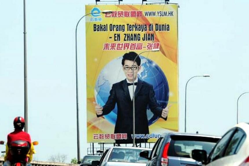 Motorists passing one of the billboards on the Penang Bridge proclaiming Zhang Jian as the future’s richest person. -- PHOTO: THE STAR/ASIA NEWS NETWORK