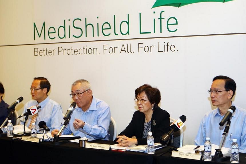 Members of the Medishield Life Review Committee speaking during the press conference held at the Suntec City Convention Centre on June 27, 2014.&nbsp;-- PHOTO: ZAOBAO&nbsp;
