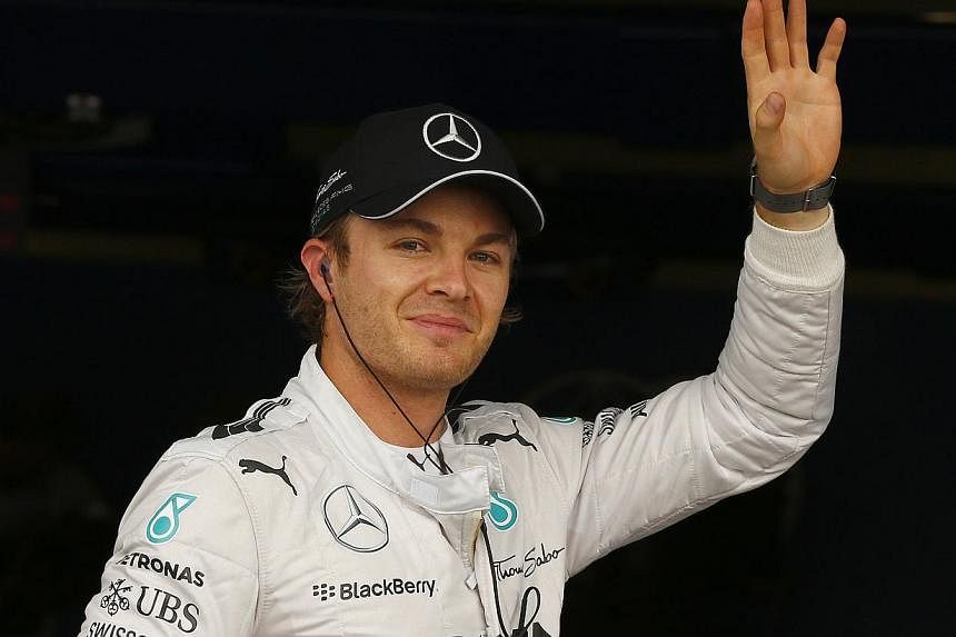 Mercedes Formula One driver Nico Rosberg of Germany celebrates his pole position ahead of the British Grand Prix at the Silverstone Race Circuit, central England, on July 5, 2014. -- PHOTO: REUTERS