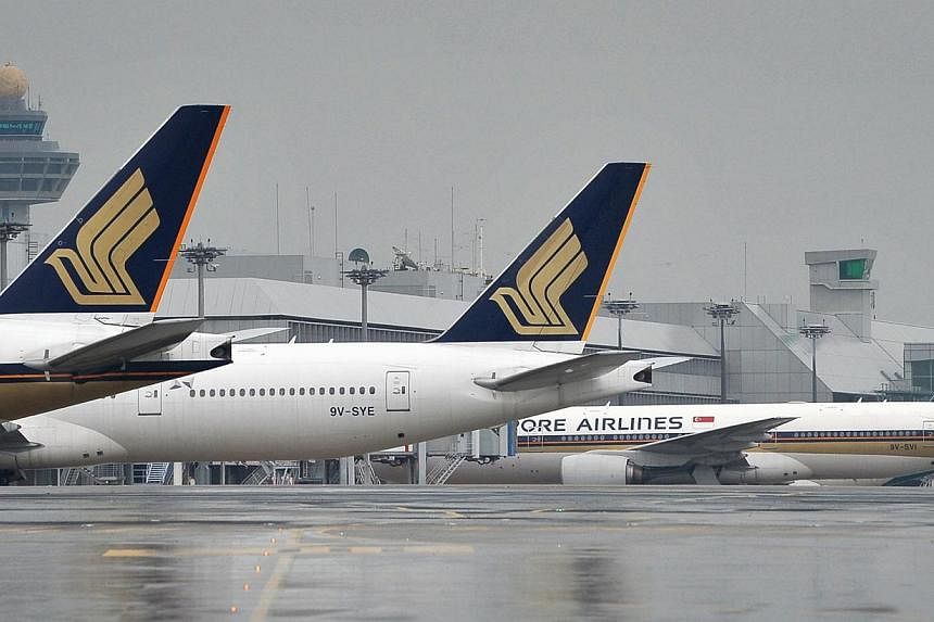 Singapore Airlines (SIA) planes lined up at the Changi Airport on April 21, 2012.&nbsp;A Singapore Airlines plane had a near miss with another aircraft while leaving Houston on Thursday night, reports said. -- PHOTO: ST FILE