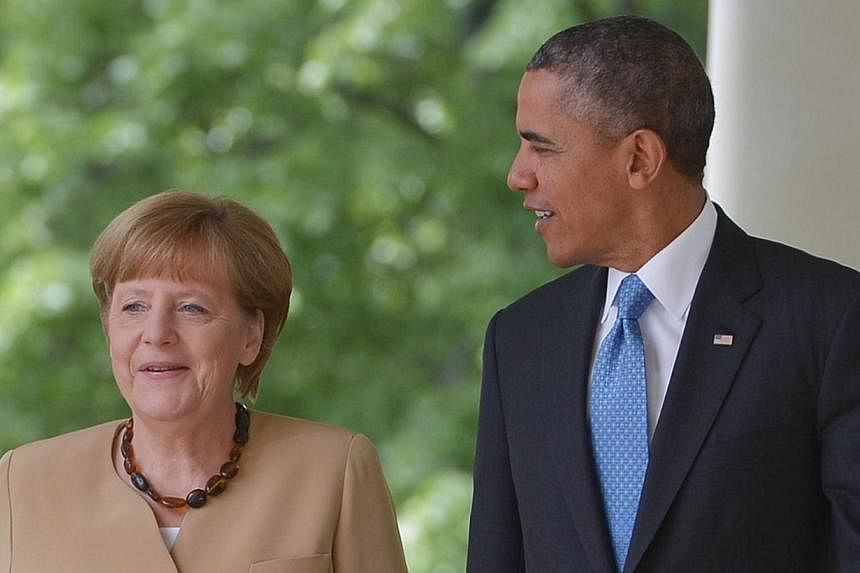 US President Barack Obama and German Chancellor Angela Merkel walk through the Colonnade on their way to a joint press conference in the Rose Garden of the White House on May 2, 2014 in Washington, DC.&nbsp;German Chancellor Angela Merkel said on Mon