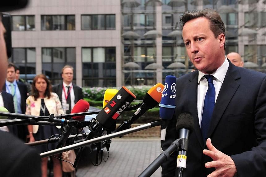 Britain Prime minister David Cameron answers journalists' questions on May 27, 2014 as he arrives to take part in the Informal European Council at the EU Headquarters in Brussels.&nbsp;Britain's Conservative-led government on Monday promised to rebal